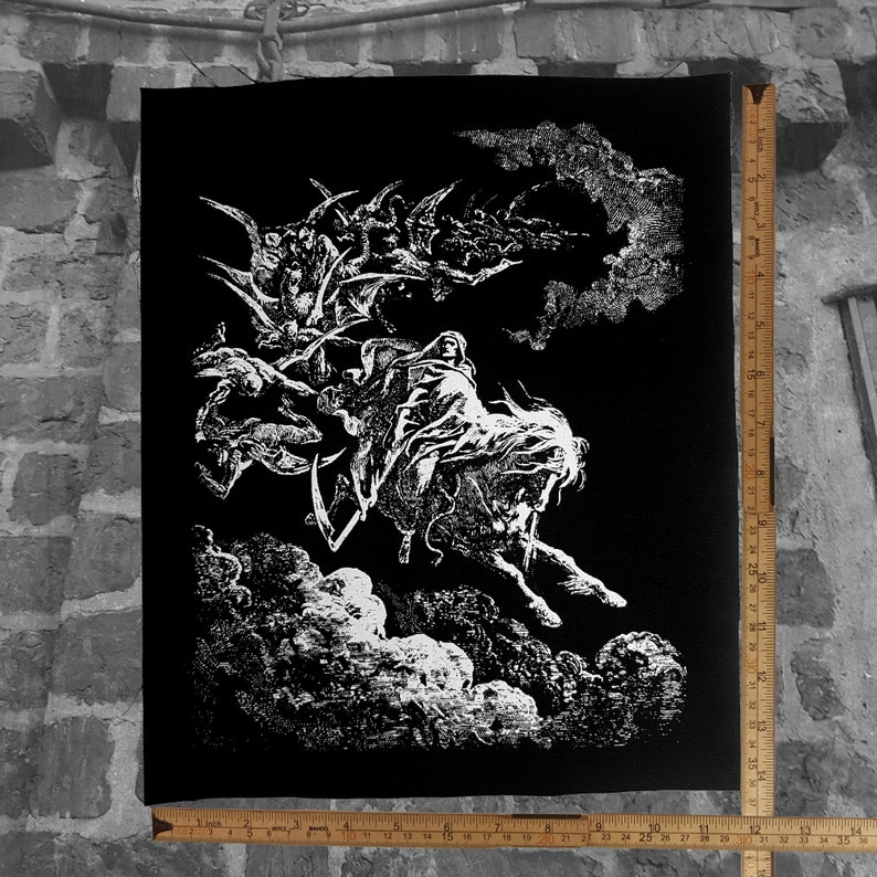 May include: Black and white illustration of a figure on horseback, surrounded by other figures and clouds. The artwork is a detailed, gothic-style drawing. The image is printed on a black canvas. A ruler is placed next to the canvas, measuring up to 36 inches.