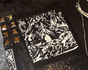 May include: Black and white patch with the text "In The Wake Of The Thord" in a gothic font. The patch features a graphic of a scene with multiple figures.