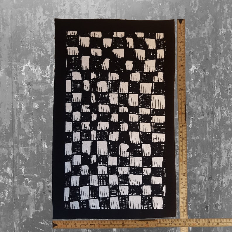 May include: Black and white checkered fabric patch with a rough, hand-painted texture. The patch is approximately 12 inches by 18 inches.