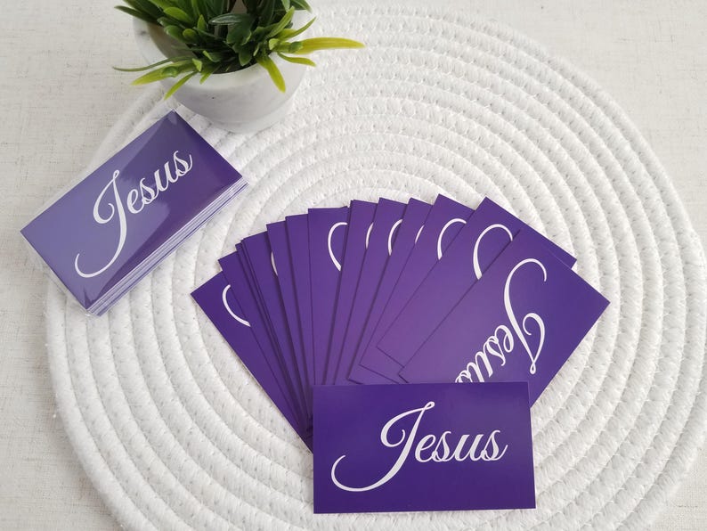 Jesus gospel tracts – Acts 4:12 salvation prayer business cards in purple; fan spread with stacked cards and a sealed 25-pack in a clear resealable cellophane bag, on white round mat with plant décor; Christian evangelism scripture cards