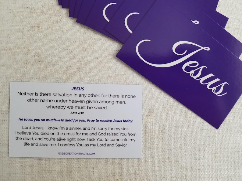 Jesus gospel tract – Acts 4:12 scripture card with salvation prayer on back; purple “Jesus” fronts in fan spread on linen background; Christian evangelism witnessing cards by God’s Creation Tracts, 25–250 pack options