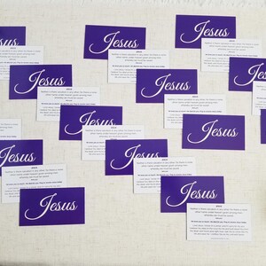 Jesus gospel tracts — Acts 4:12 Christian scripture cards with salvation prayer; mix of purple “Jesus” fronts and backs scattered on linen surface with greenery; 25-pack (25–250 options).