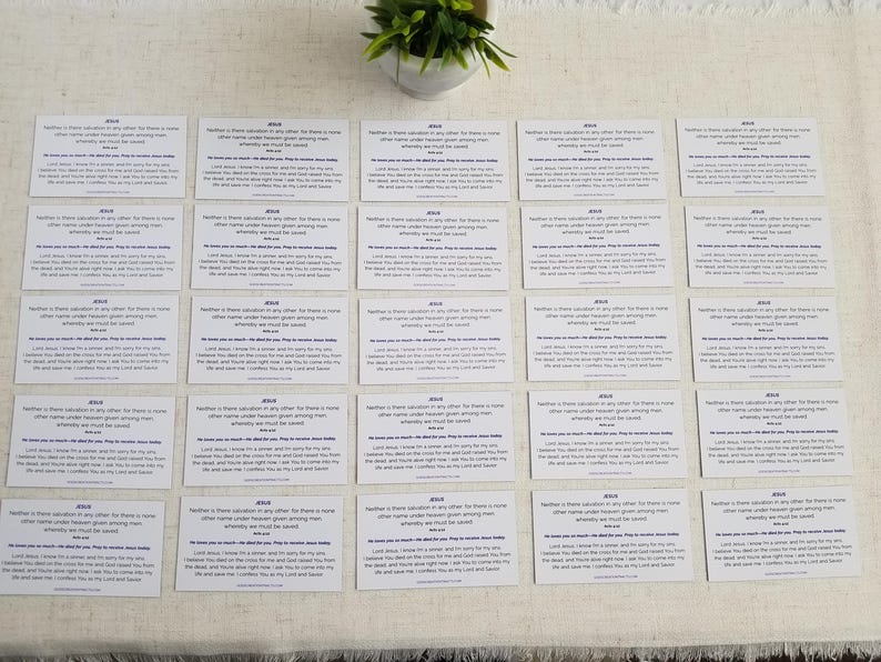 Jesus gospel tracts — Acts 4:12 Christian scripture cards with salvation prayer; backs arranged in a grid on linen surface with small plant décor; 25-pack (25–250 options).