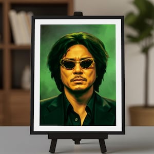 May include: A framed digital portrait print featuring a person with dark, messy hair and a light scar on their forehead. They are wearing gold-rimmed sunglasses and a dark collared shirt under a dark blazer, set against a vibrant green background.