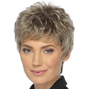 May include: A woman with short, layered, light brown and blonde hair. She is wearing a black collared shirt. The image is a head and shoulders shot, with a white background.