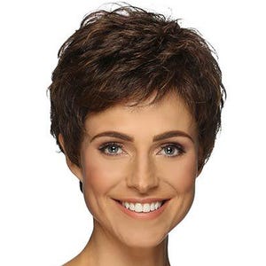 May include: A woman wearing a short, layered brown wig with a natural-looking style. The wig has a slightly tousled texture and a dark brown color with subtle highlights. She is wearing a black camisole top.