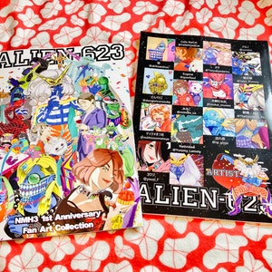 May include: A colorful fan art collection book titled "ALIEN-623" featuring a variety of illustrations. The cover features a group of characters in a vibrant, chaotic scene. The back cover lists the artists who contributed to the collection.