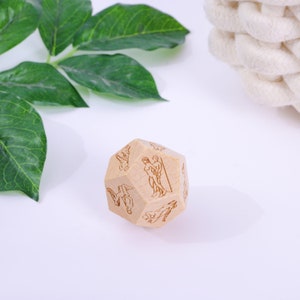 a wooden dice sitting on top of a white table