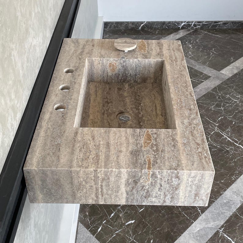 May include: A rustic wooden sign with the text "Welcome to our home" in white lettering. The sign features a distressed finish and a simple, inviting design, perfect for a front porch or entryway.