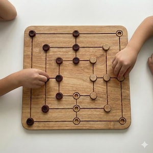 May include: A wooden Nine Men's Morris board game with dark brown and light brown game pieces. The board is square with carved lines and circular holes. Two hands are seen playing the game on a white surface.