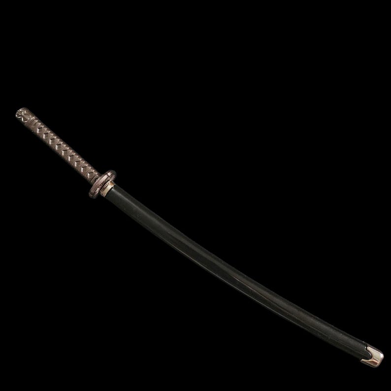 May include: A katana sword with a black blade and a silver-colored handle. The handle has a textured, woven design. The sword's guard is a silver-colored ring. The tip of the blade has a silver-colored cap. The background is black.