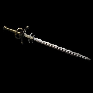 May include: An ornamental sword with a silver blade and an elaborate gold-coloured hilt. The blade has a wavy edge, and the hilt features detailed scrollwork and a decorative hand guard. The sword is set against a black backdrop.