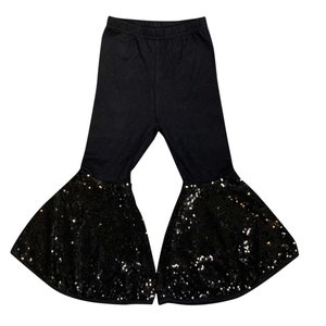 May include: Black flared pants with a sequined bottom. The pants are made of a soft, stretchy fabric and have a comfortable fit.
