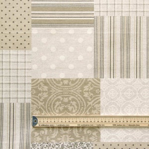 May include: A patchwork fabric sample featuring various patterns in beige and white. The patterns include polka dots, stripes, checks, and a floral design. A ruler is positioned at the bottom of the image.