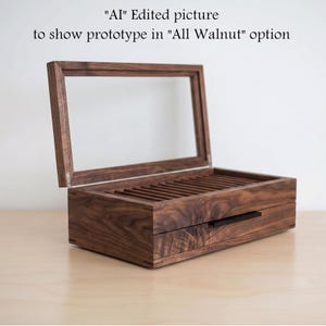 May include: A rectangular dark brown walnut wood storage box with a hinged glass lid and a pull-out drawer featuring a thin black handle. The interior contains multiple parallel slots. Text above reads: "AI" Edited picture to show prototype in "All Walnut" option.