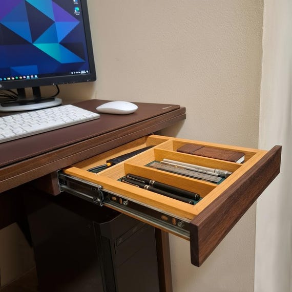A solid walnut drawer that mounts *under* your desk — completely hidden extra storage that most people don't know exists as a handmade product.