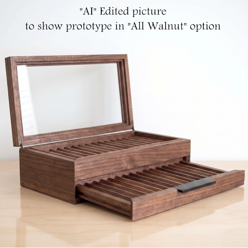 May include: A dark brown walnut wood display case with a hinged glass lid and a pull-out drawer. The interior features multiple grooved slots for organizing items. Text above reads: "AI" Edited picture to show prototype in "All Walnut" option.