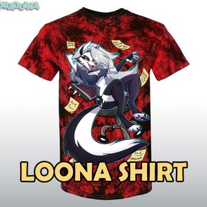 May include: A red t-shirt with a black and white cartoon image of a wolf-like character with a long tail sitting on a chair. The character is wearing a black outfit and has a white face with blue eyes. The shirt has the text "LOONA SHIRT" printed on the bottom.