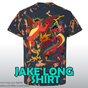 May include: Black t-shirt with a bleach wash effect, featuring a cartoon graphic of two dragons in red, yellow, and blue. The shirt has the text "JAKE LONG SHIRT" in a turquoise font. The pattern will differ in each piece.
