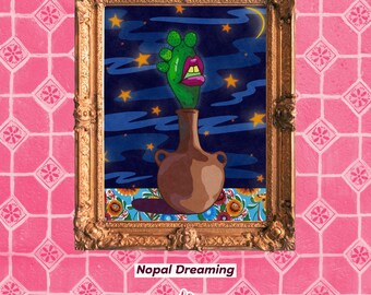 May include: A framed artwork titled Nopal Dreaming featuring a brown clay vase with a green cactus plant that has bright pink lips and yellow teeth. The background shows a dark blue night sky with yellow stars and a crescent moon above flowers.