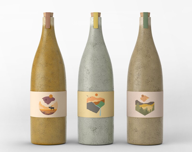 May include: Three glass bottles with cork tops and labels featuring nature-inspired designs. The bottles are in various shades of brown, gray, and green. The labels feature illustrations of a mountain range, a deer, and a forest.