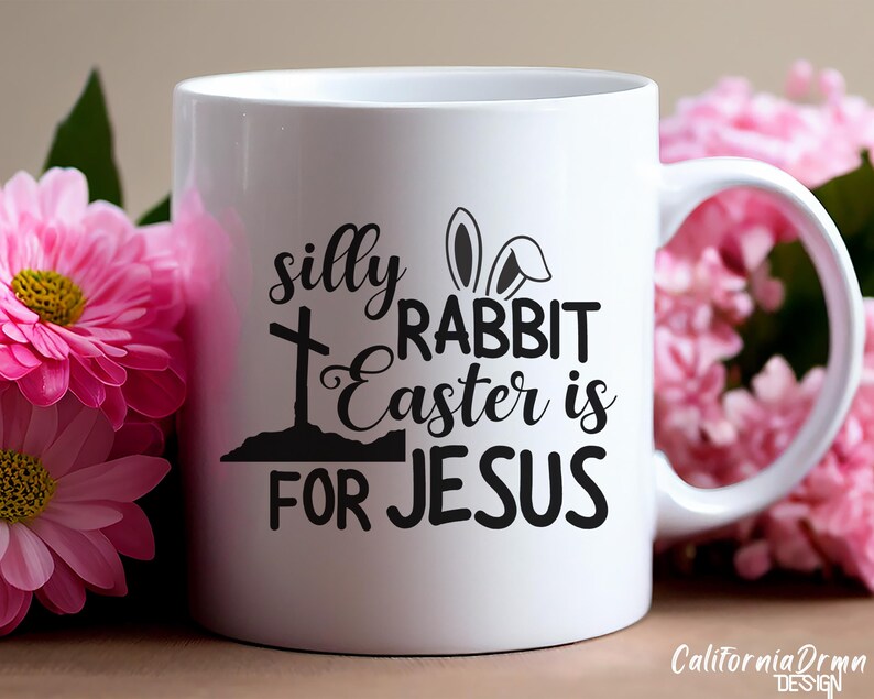 May include: White ceramic mug with a black design that says "silly rabbit easter is for jesus" with a cross and bunny ears.