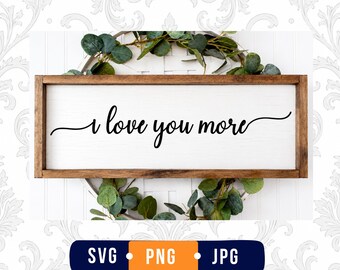 May include: A rectangular wooden sign with a white background and a dark brown frame. The text "I love you more" is written in black cursive script across the center. Below the sign, a dark blue rectangular label displays the text "SVG PNG JPG".