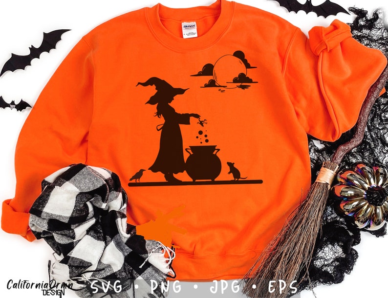 May include: Bright orange sweatshirt featuring a black silhouette of a witch stirring a cauldron under a full moon. A crow and a mouse are also depicted. The design is perfect for Halloween. The bottom of the sweatshirt has the words "California Drama Design" and the file types: SVG, PNG, JPG, EPS.
