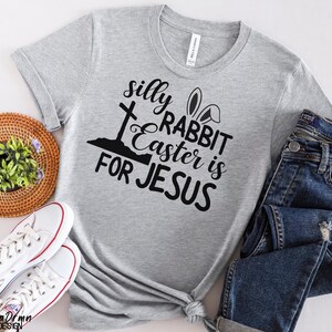 May include: Gray t-shirt with a black graphic that says "silly rabbit easter is for jesus" with a cross and bunny ears.