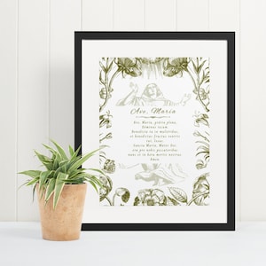 May include: A framed print with a black frame and a white background. The print features a vintage illustration of a woman in a floral wreath with the text "Ave. Maria, gr&aacute;tia plena, it Benedictar fract, Santa Maria, Mater, ore pro nobis peccatorches".