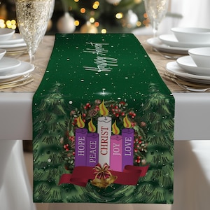 May include: A green Advent table runner with a festive design. It features four candles with the words "Hope, Peace, Christ, Joy, Love" and a red ribbon. The background includes Christmas trees and the text "Happy Advent".
