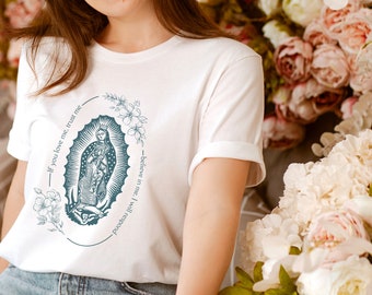 May include: White t-shirt with a blue graphic of the Virgin Mary. The graphic includes the text "If you love me, trust me - believe in me, I will protect you".