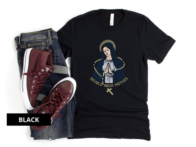 May include: Black t-shirt with a graphic of a woman in a blue robe with a gold rosary and the text "Behold Your Mother".