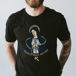 May include: Black t-shirt with a graphic of the Virgin Mary with a rosary and the text "Behold your mother".