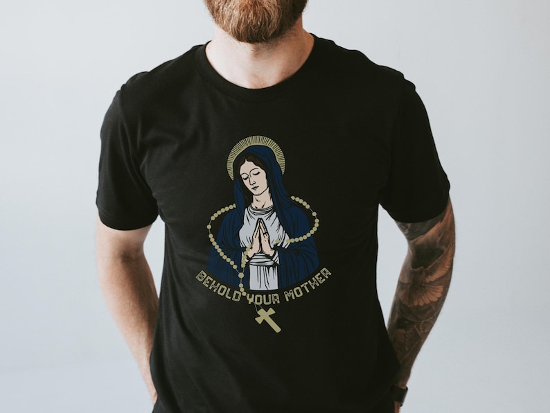 May include: Black t-shirt with a graphic of the Virgin Mary with a rosary and the text "Behold your mother".
