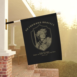 May include: A black flag with a gold shield and a woman in armor holding a sword. The text on the flag reads "Go Forward Bravely", "Fear Nothing", "Trust in God; All Will Be Well", and "Joan of Arc".