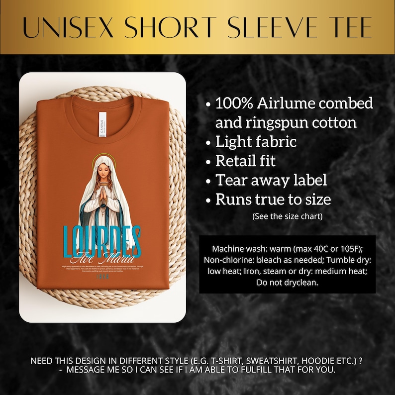 May include: A brown short-sleeved t-shirt with a graphic of the Virgin Mary and the text "Lourdes Ave Maria". The shirt is made of 100% airlume combed and ringspun cotton and has a retail fit.