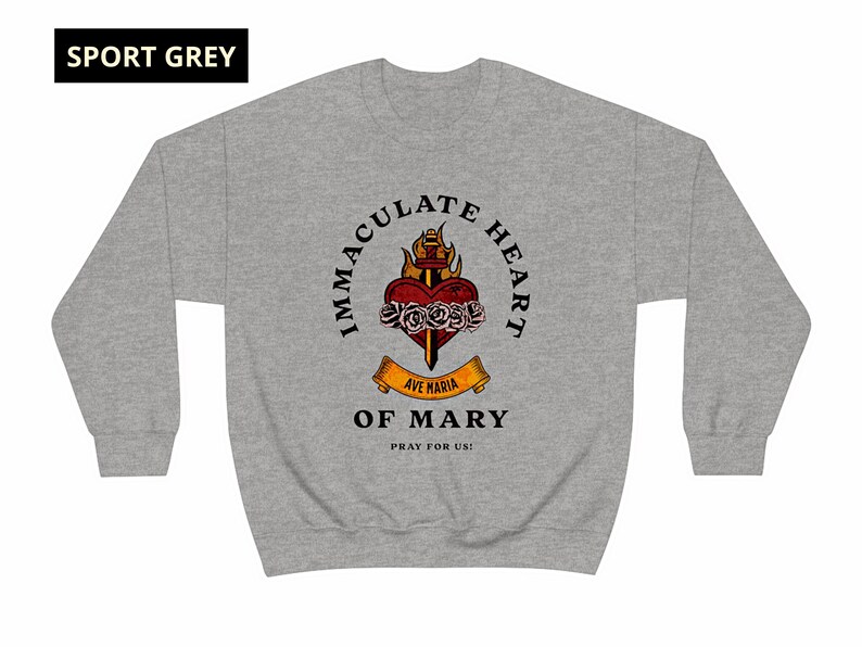 May include: A gray sweatshirt with a graphic of the Immaculate Heart of Mary. The graphic features a heart with a sword, flames, and roses. The text reads "Immaculate Heart of Mary" and "Ave Maria" with a banner that says "Pray for Us!"