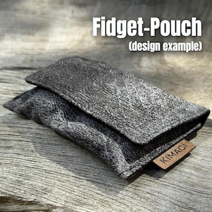 May include: A grey Fidget-Pouch with a textured surface and a flap closure. The pouch has a small brown leather tag that reads "KIMACI". The text "Fidget-Pouch (design example)" is displayed above the pouch.