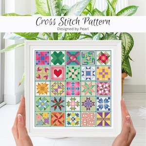 May include: A framed cross stitch pattern with a grid of colourful quilt block designs. The text "Cross Stitch Pattern Designed by Pearl" is at the top. The blocks include various geometric and floral patterns in shades of pink, green, blue, and yellow.