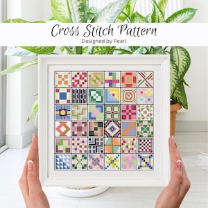 May include: A framed cross-stitch pattern with a white border. The pattern features a grid of colourful, geometric designs in various colours, including blue, green, red, and yellow. The text "Cross Stitch Pattern" and "Designed by Pearl" are at the top.