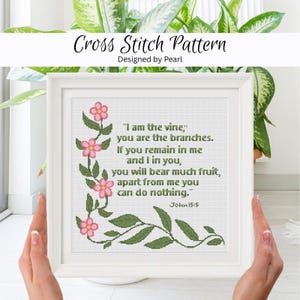May include: A framed cross stitch pattern with the text "I am the vine," and floral accents. The design includes pink flowers and green leaves, with the text from John 15:5. The words "Cross Stitch Pattern" and "Designed by Pearl" are at the top.