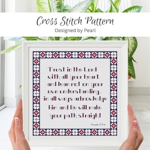 May include: A square cross stitch pattern in a white frame featuring the text Trust in the Lord with all your heart, and lean not on your own understanding, in all ways acknowledge Him and He will make your path straight, Proverbs 3:5-6.