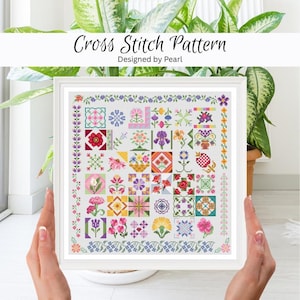 May include: A framed cross stitch pattern with a white border. The pattern features a variety of colorful floral designs arranged in a grid. The text "Cross Stitch Pattern Designed by Pearl" is at the top.