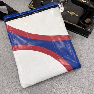 Laptop / tablet bag made from upcycled truck tarpaulin with orange lining.