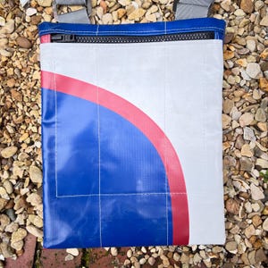 Laptop / tablet bag made from upcycled truck tarpaulin with orange lining.