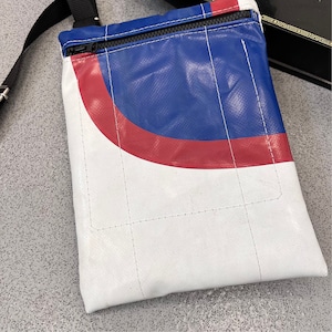 Satchel / utility bag made from upcycled truck tarpaulin with orange lining.