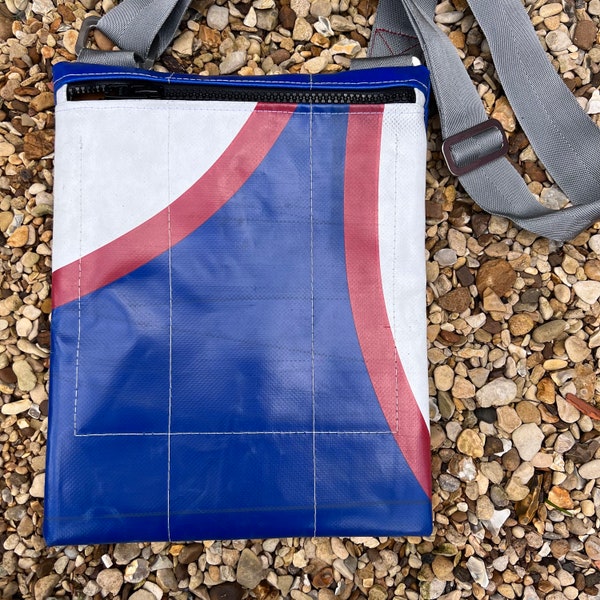 Laptop / tablet bag made from upcycled truck tarpaulin with orange lining.