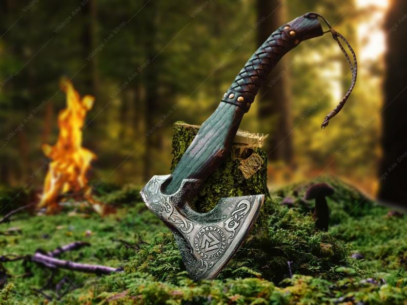 May include: A decorative axe with a dark green and brown wooden handle and a silver blade with intricate carvings. The blade features a stylized knotwork design and a symbol resembling a runic letter. The axe is resting on a tree stump in a mossy forest setting.