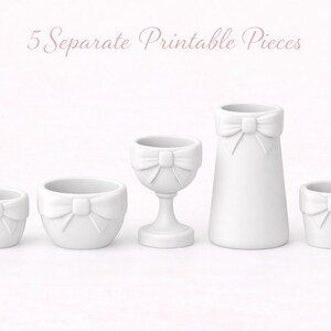 May include: Five white ceramic decorative pieces, including small pots, a goblet, and a vase, each adorned with a bow. The text "5 Separate Printable Pieces" is above the objects. These items are likely for home decor or crafting.